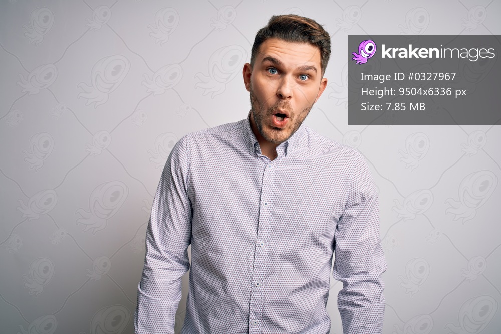 Young business man with blue eyes standing over isolated background afraid and shocked with surprise expression, fear and excited face.