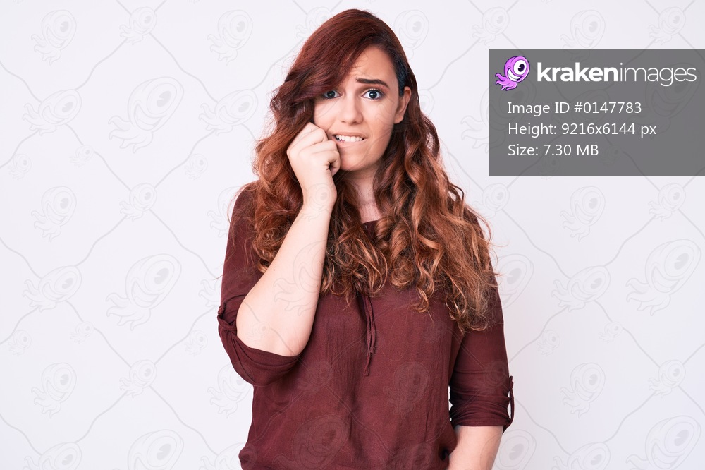 Young beautiful woman wearing casual clothes looking stressed and nervous with hands on mouth biting nails. anxiety problem. 