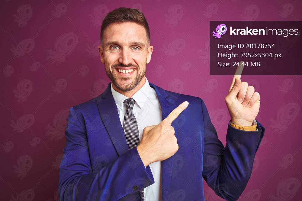 Young handsome business man over purple isolated background smiling and looking at the camera pointing with two hands and fingers to the side.