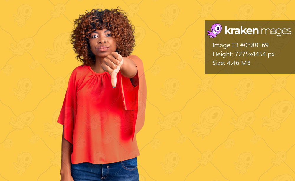 Young african american woman wearing casual clothes looking unhappy and angry showing rejection and negative with thumbs down gesture. bad expression. 