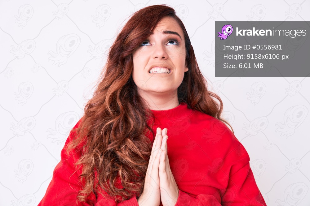 Young beautiful woman wearing casual clothes begging and praying with hands together with hope expression on face very emotional and worried. begging. 