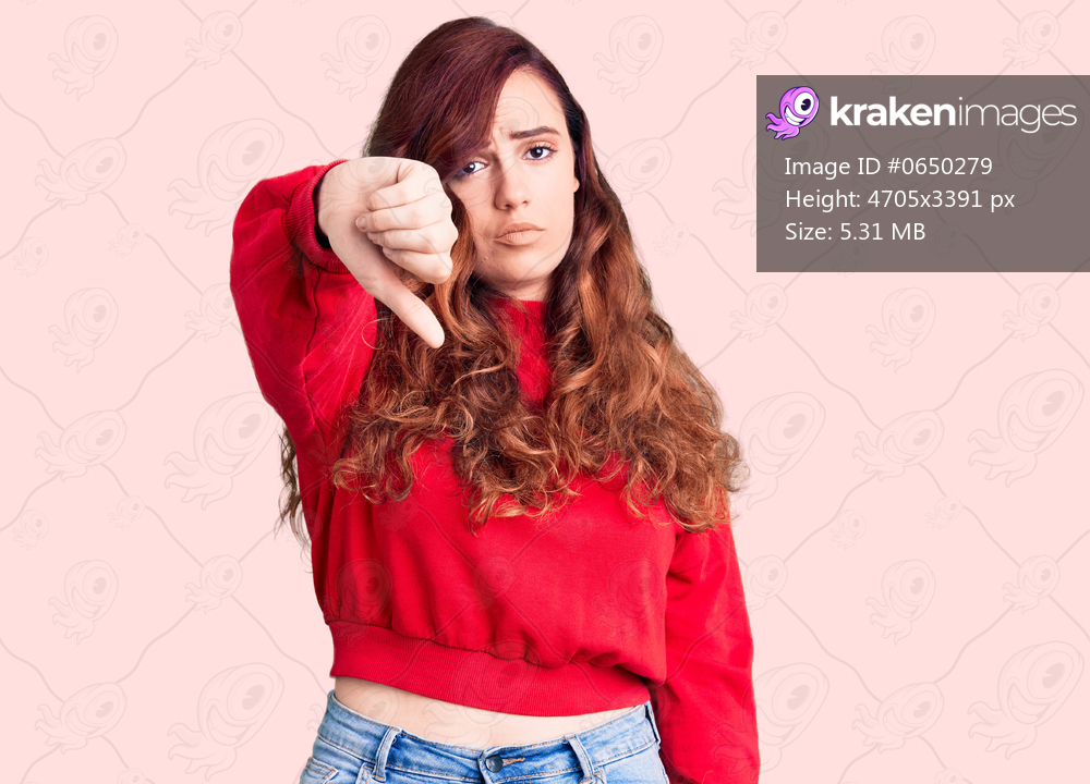 Young beautiful woman wearing casual winter sweater looking unhappy and angry showing rejection and negative with thumbs down gesture. bad expression. 