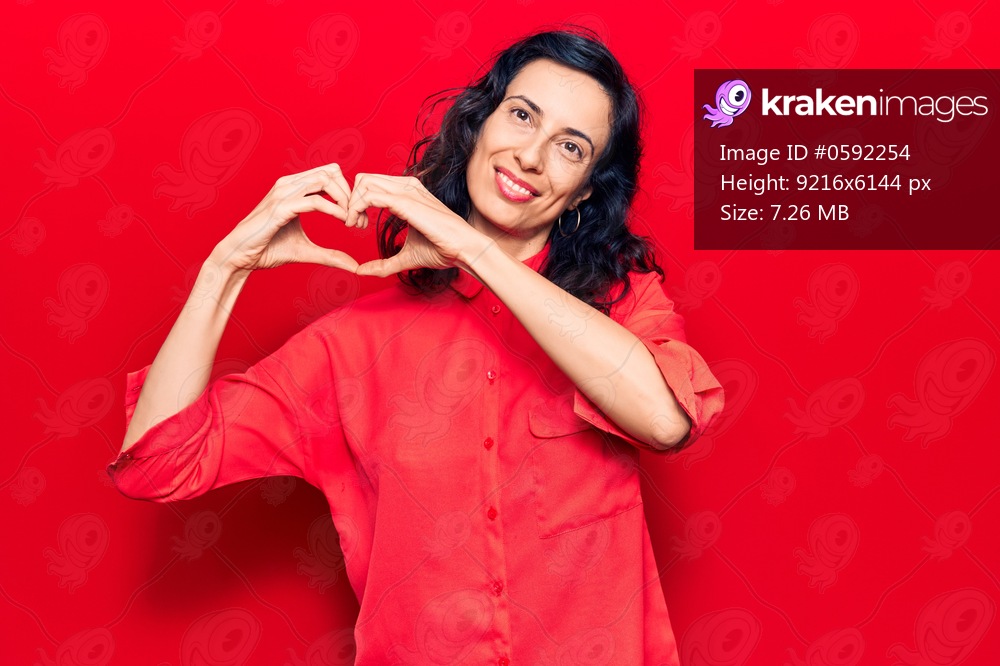 Young beautiful hispanic woman wearing casual clothes smiling in love showing heart symbol and shape with hands. romantic concept. 