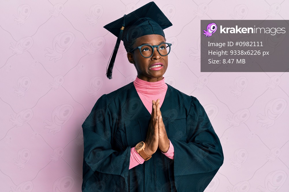 Young african american girl wearing graduation cap and ceremony robe begging and praying with hands together with hope expression on face very emotional and worried. begging. 