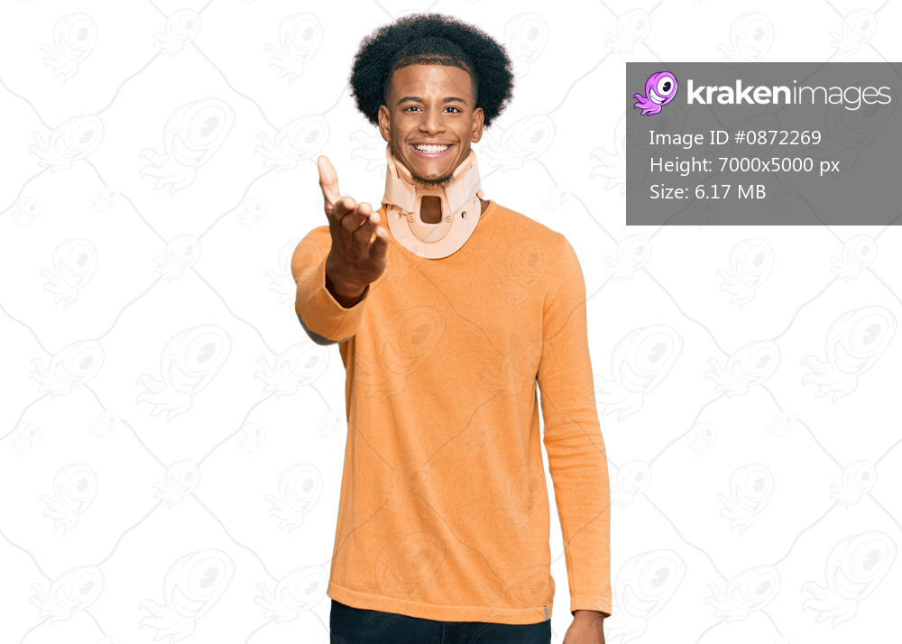 African american man with afro hair wearing cervical neck collar smiling friendly offering handshake as greeting and welcoming. successful business. 