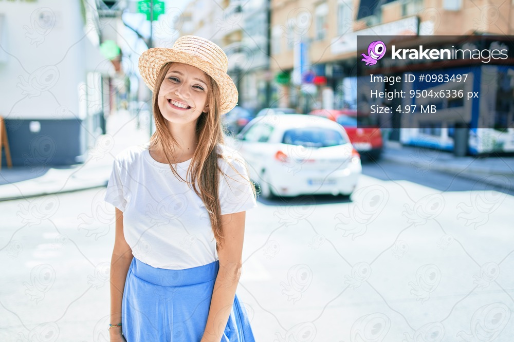 Young blonde woman on vacation smiling happy walking at street of city