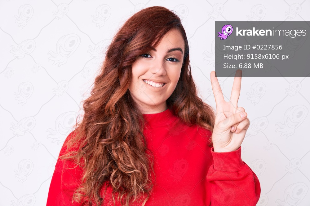 Young beautiful woman wearing casual clothes showing and pointing up with fingers number two while smiling confident and happy. 