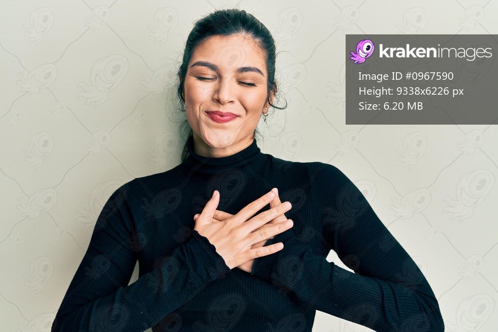 Young hispanic woman wearing casual clothes smiling with hands on chest, eyes closed with grateful gesture on face. health concept. 