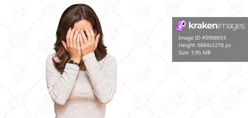 Young brunette woman wearing casual clothes and glasses with sad expression covering face with hands while crying. depression concept. 