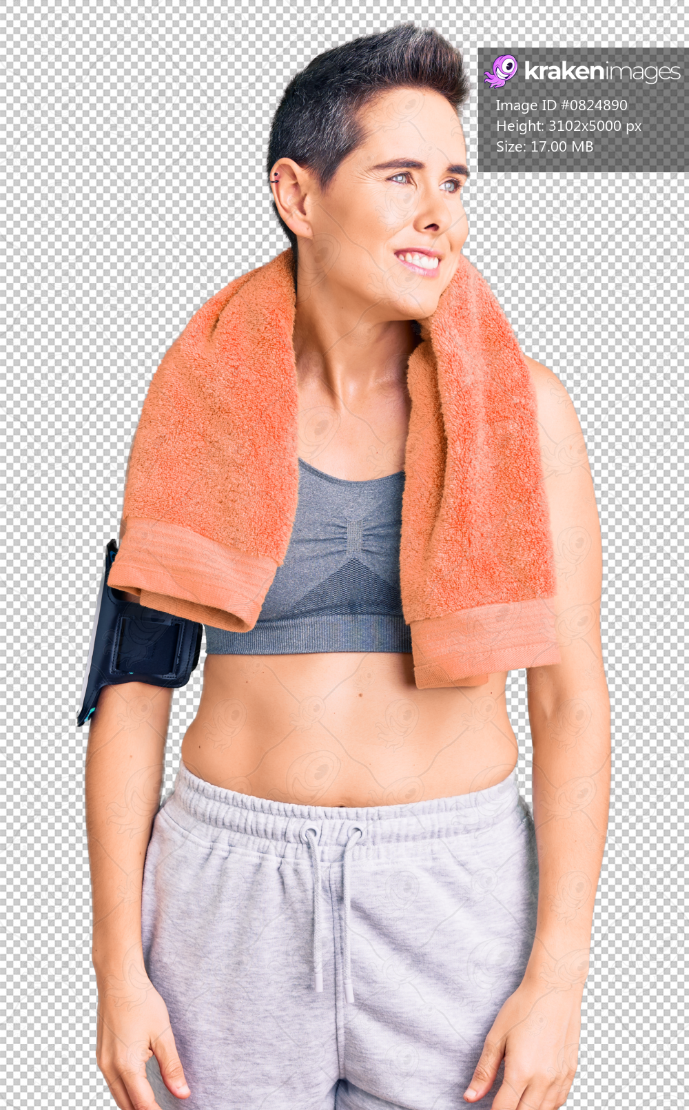 Young woman with short hair wearing sportswear and towel using smartphone looking away to side with smile on face, natural expression. laughing confident.