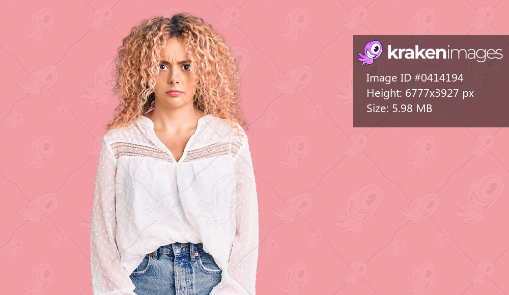 Young blonde woman with curly hair wearing elegant summer shirt skeptic and nervous, frowning upset because of problem. negative person. 