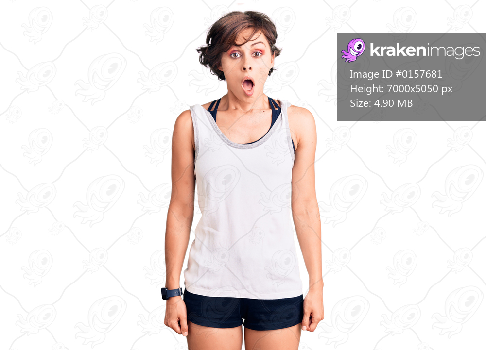 Beautiful young woman with short hair wearing casual sport clothes scared and amazed with open mouth for surprise, disbelief face 