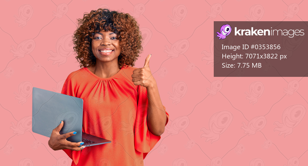 Young african american woman working using computer laptop smiling happy and positive, thumb up doing excellent and approval sign 