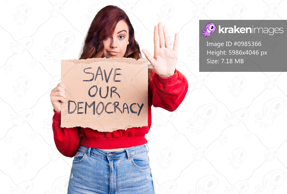 Young beautiful woman holding save our democracy protest banner with open hand doing stop sign with serious and confident expression, defense gesture 