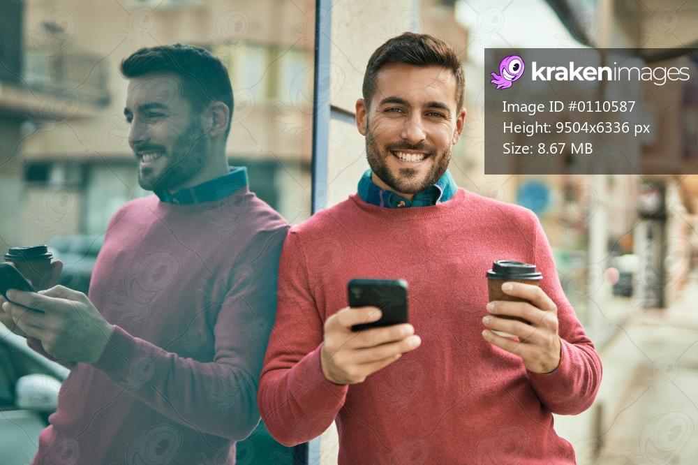 Young hispanic man using smartphone and drinking coffee at the city.