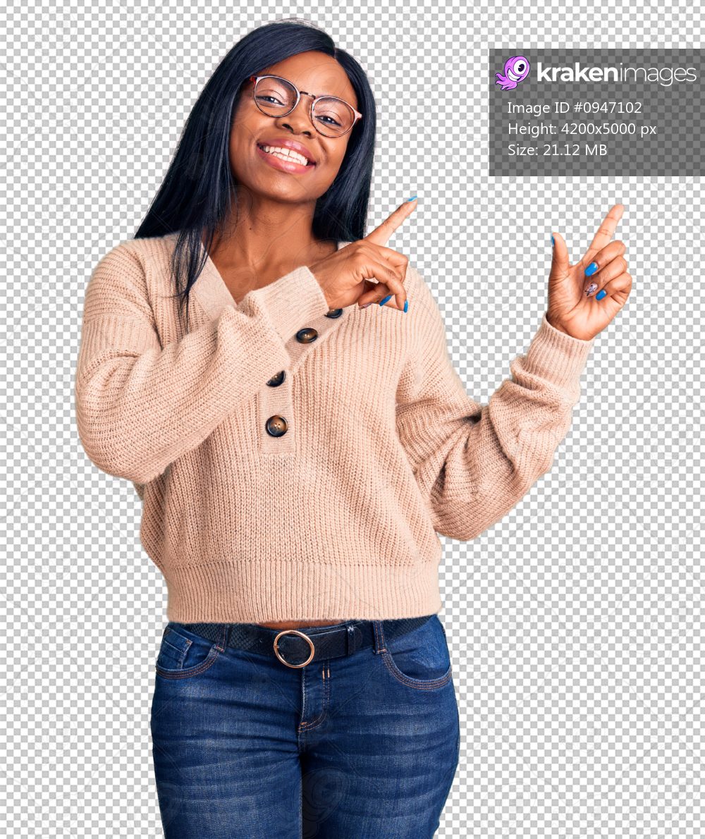 Young african american woman wearing casual clothes smiling and looking at the camera pointing with two hands and fingers to the side.