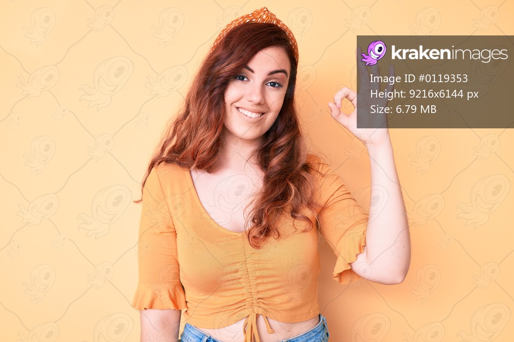 Young beautiful woman wearing casual clothes smiling positive doing ok sign with hand and fingers. successful expression. 