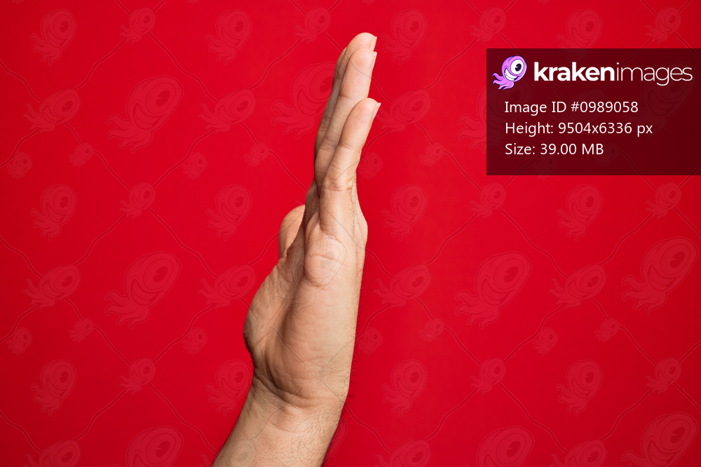 Hand of caucasian young man showing fingers over isolated red background showing side of stretched hand, pushing and doing stop gesture