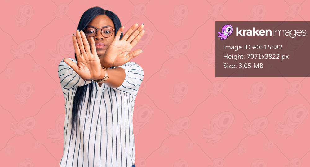 Young african american woman wearing casual clothes and glasses rejection expression crossing arms and palms doing negative sign, angry face 
