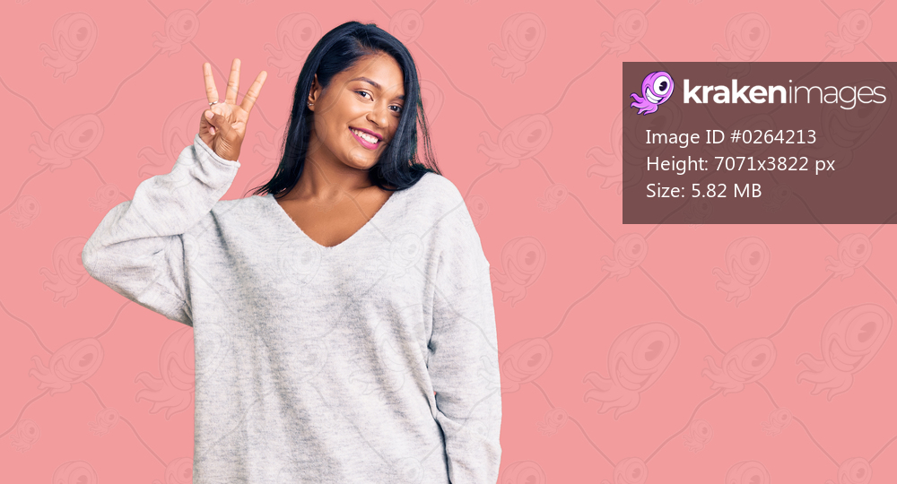 Hispanic woman with long hair wearing casual clothes showing and pointing up with fingers number three while smiling confident and happy. 