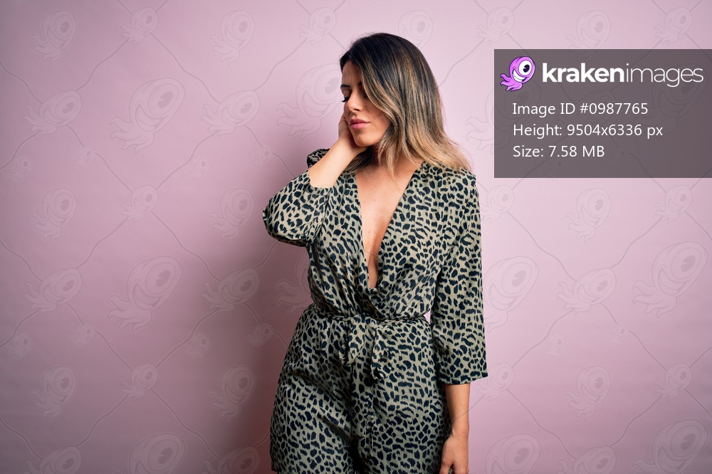 Young beautiful woman wearing fashion urban clothes, model wearing casual street style standing over pink background