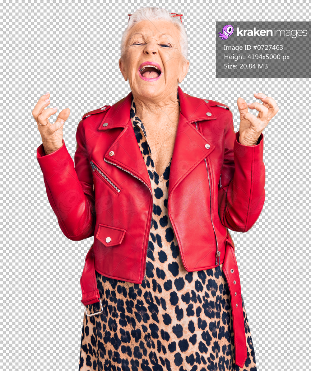 Senior beautiful woman with blue eyes and grey hair wearing a modern style with a red leather jacket crazy and mad shouting and yelling with aggressive expression and arms raised. frustration concept.