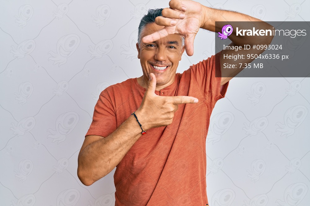 Handsome middle age mature man wearing casual clothes smiling making frame with hands and fingers with happy face. creativity and photography concept. 
