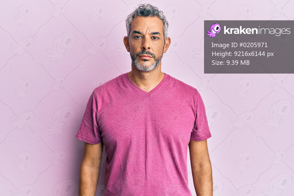 Middle age grey-haired man wearing casual clothes with serious expression on face. simple and natural looking at the camera. 
