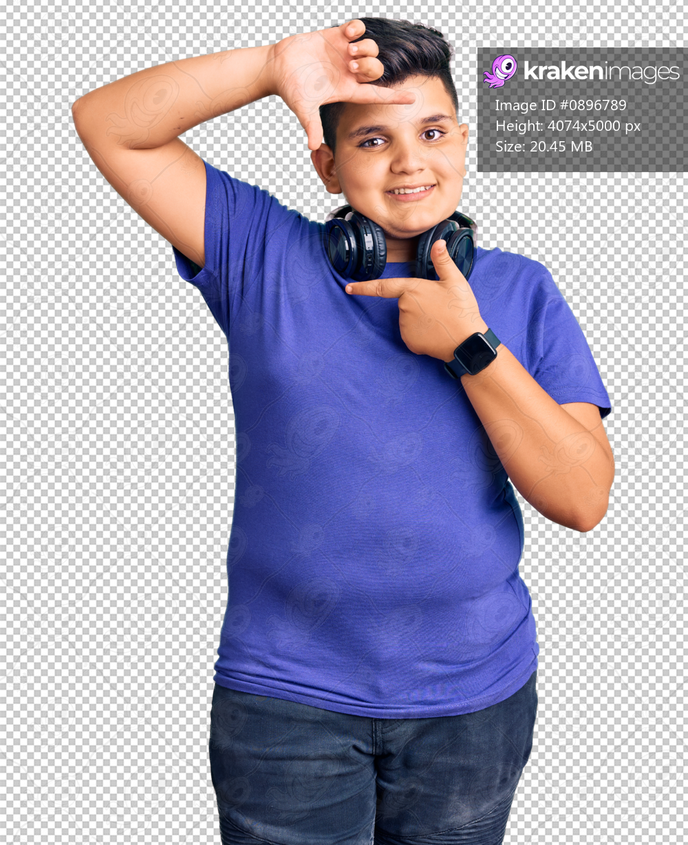 Little boy kid listening to music wearing headphones smiling making frame with hands and fingers with happy face. creativity and photography concept.