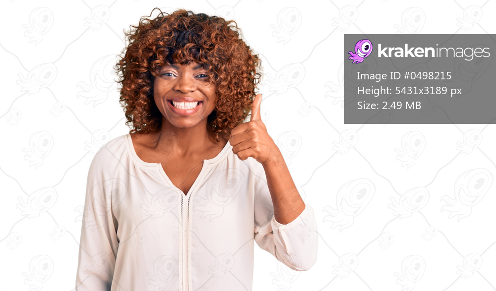 Young african american woman wearing casual clothes smiling happy and positive, thumb up doing excellent and approval sign 