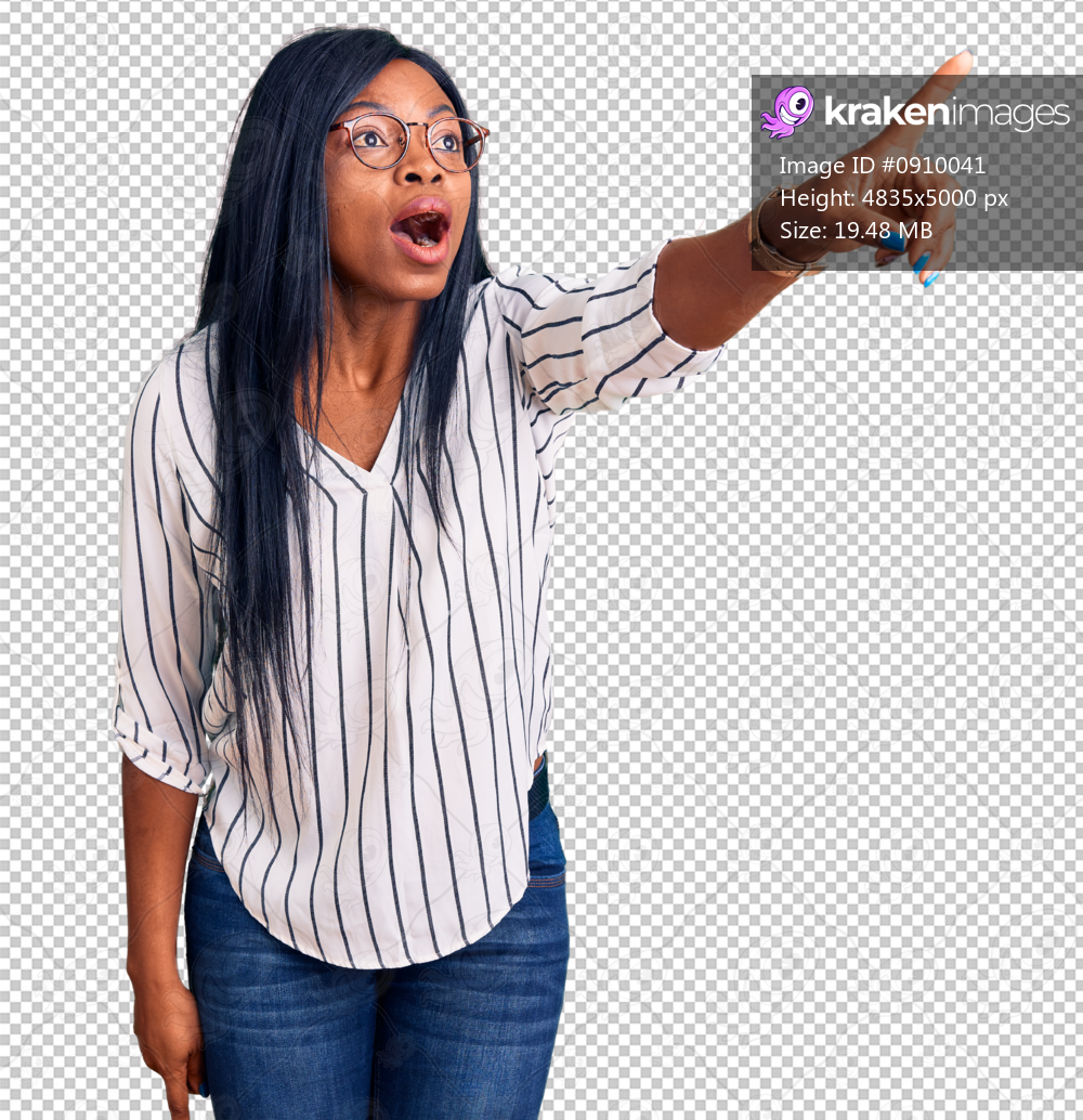 Young african american woman wearing casual clothes and glasses pointing with finger surprised ahead, open mouth amazed expression, something on the front
