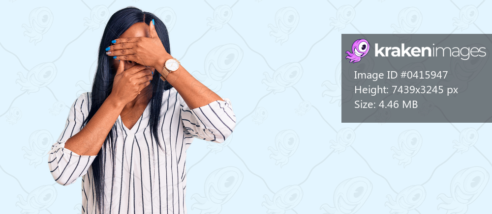 Young african american woman wearing casual clothes and glasses covering eyes and mouth with hands, surprised and shocked. hiding emotion 
