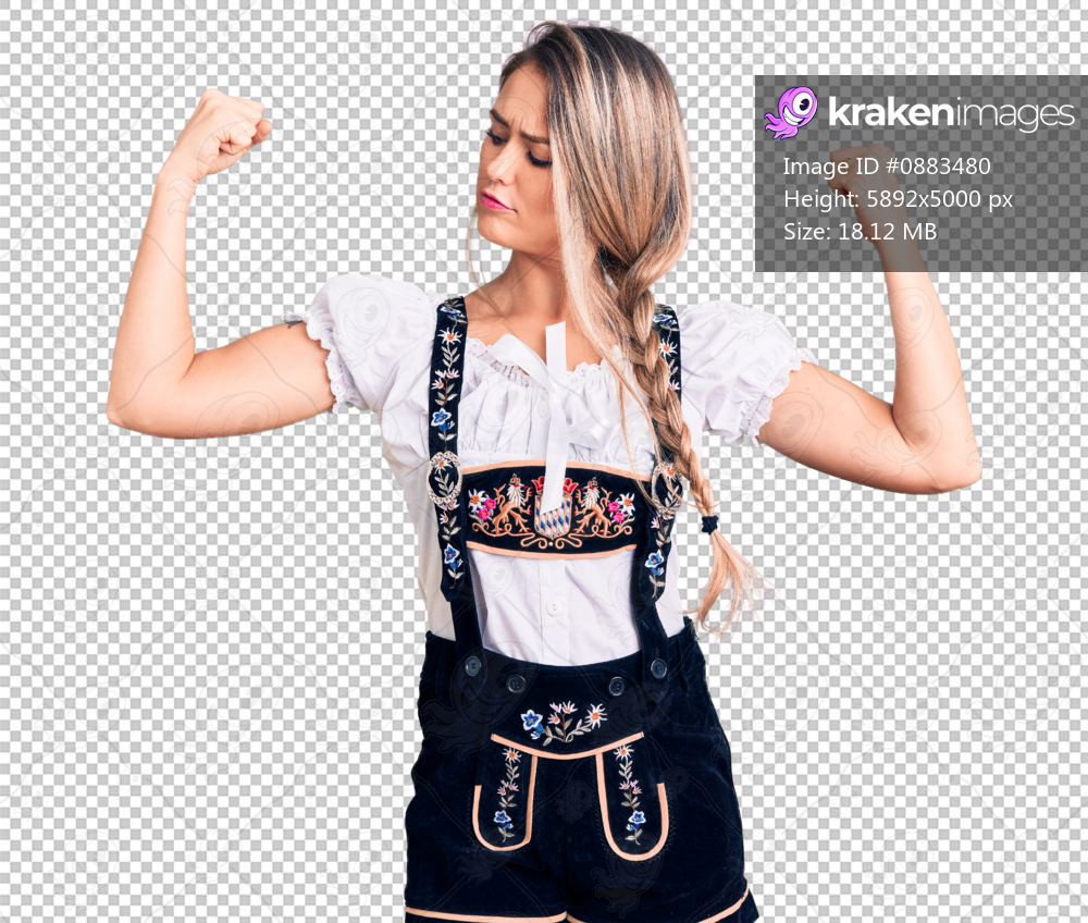 Young beautiful blonde woman wearing oktoberfest dress showing arms muscles smiling proud. fitness concept.