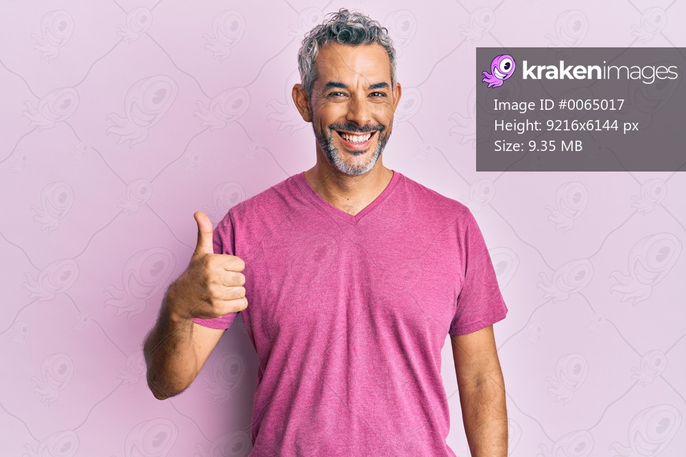 Middle age grey-haired man wearing casual clothes smiling happy and positive, thumb up doing excellent and approval sign 